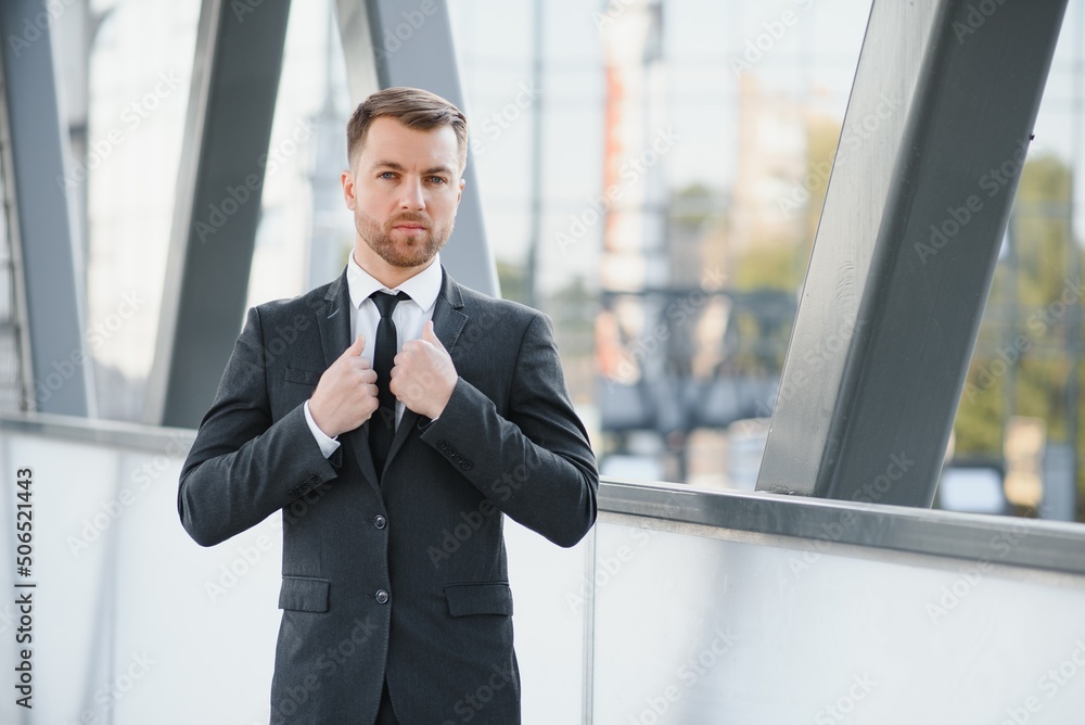 Handsome male model posing wearing a back suit. Handsome male model posing wearing a back suit.