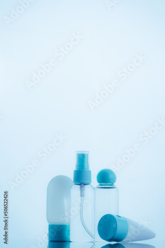 Means for face and body care. A complex of organic care products. Bottles for the transportation of cosmetics traveling by plane. Blue color scheme.