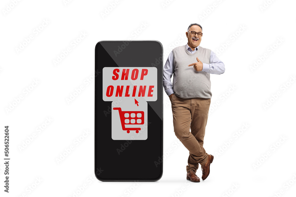 Mature man leaning on a big mobile phone with text shop online and pointing Mature man leaning on a big mobile phone with text shop online and pointing