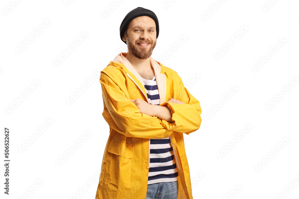 Young fisherman in a yellow raincoat posing and smiling at camera Young fisherman in a yellow raincoat posing and smiling at camera