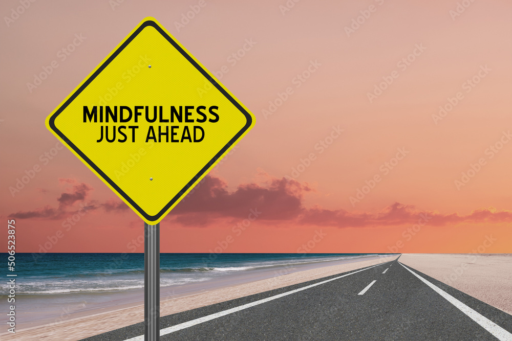 Mindfulness just ahead road sign on nature background.