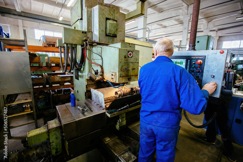 Factory engineer working on CNC lathe machine © Mulderphoto