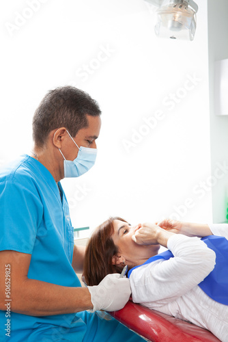 Orthodontic specialist dentist treating an adult female patient