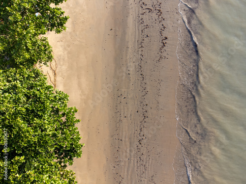Drone top view of the beach with greenish water © Rodrigo