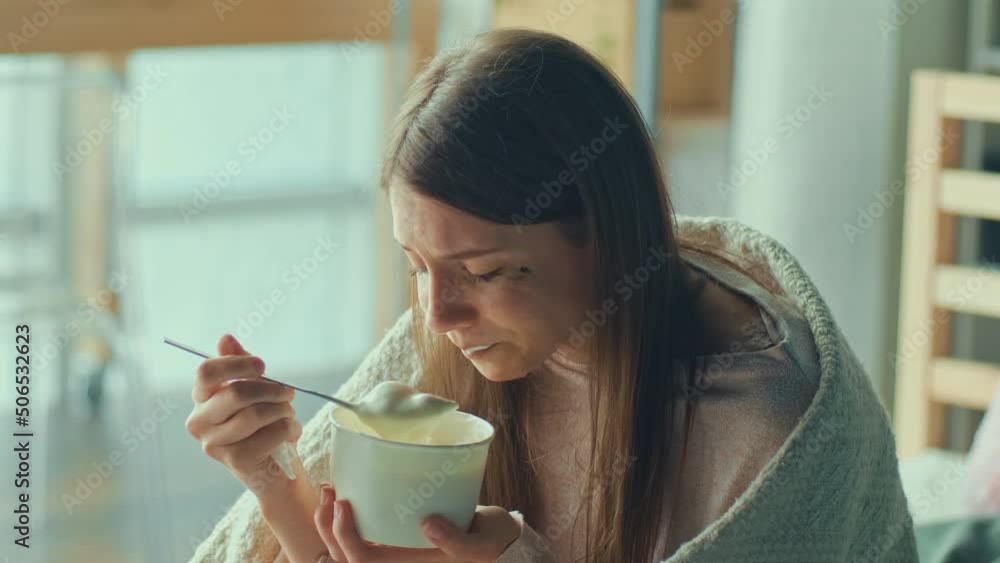 Heartbroken Girl Sitting on Sofa, Crying, Eating Ice Cream. Upset Woman Wrapped in Blanket Worry Separation or Divorce. Atmosphere of Depression. Difficult Period of Life Having Psychological Problems Heartbroken Girl Sitting on Sofa, Crying, Eating Ice Cream. Upset Woman Wrapped in Blanket Worry Separation or Divorce. Atmosphere of Depression. Difficult Period of Life Having Psychological Problems