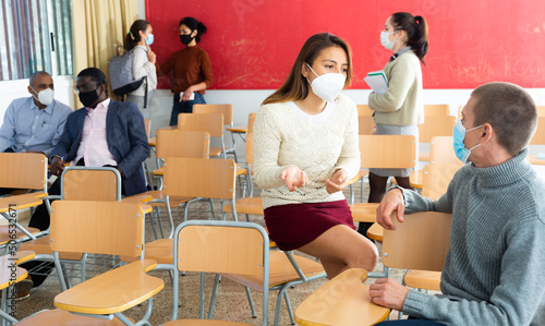 Students wearing protective mask in university classroom