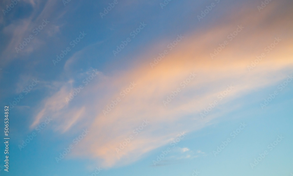 Summer sky. Cumulus clouds on a blue background. Partly cloudy.