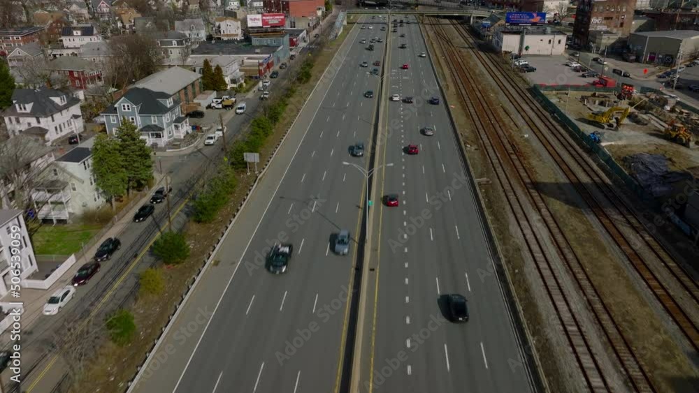 Busy multilane trunk road on suburbs. Tilt up reveal of cityscape and downtown skyscrapers in distance. Boston, USA Busy multilane trunk road on suburbs. Tilt up reveal of cityscape and downtown skyscrapers in distance. Boston, USA