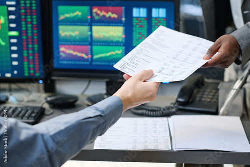 Canvas Print Unrecognizable busy stock trading specialist sitting in front of computers givin
