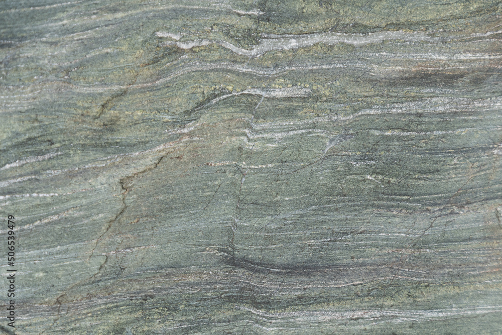Slate stone wall as background. Textured surface of geological layer of soil Slate stone wall as background. Textured surface of geological layer of soil
