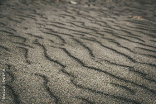 Sand waves and texture of desert as background. Lack of water  hot dry soil. Lifeless landscape without vegetation