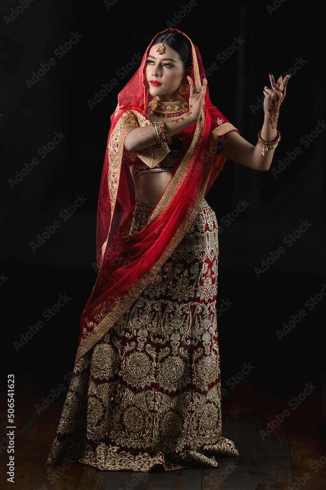 asian woman in tradition indian costume in indian dancing pose asian woman in tradition indian costume in indian dancing pose