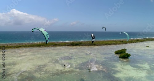 Group People kitesurf on turquoise caribbean sea, Los Roques, adventure unspoilt island, Aerial shot