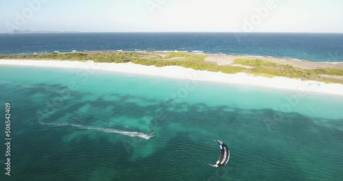 Man freestyle kitesurf turquoise sea water, white sand beach, Los Roques, aerial shot photo