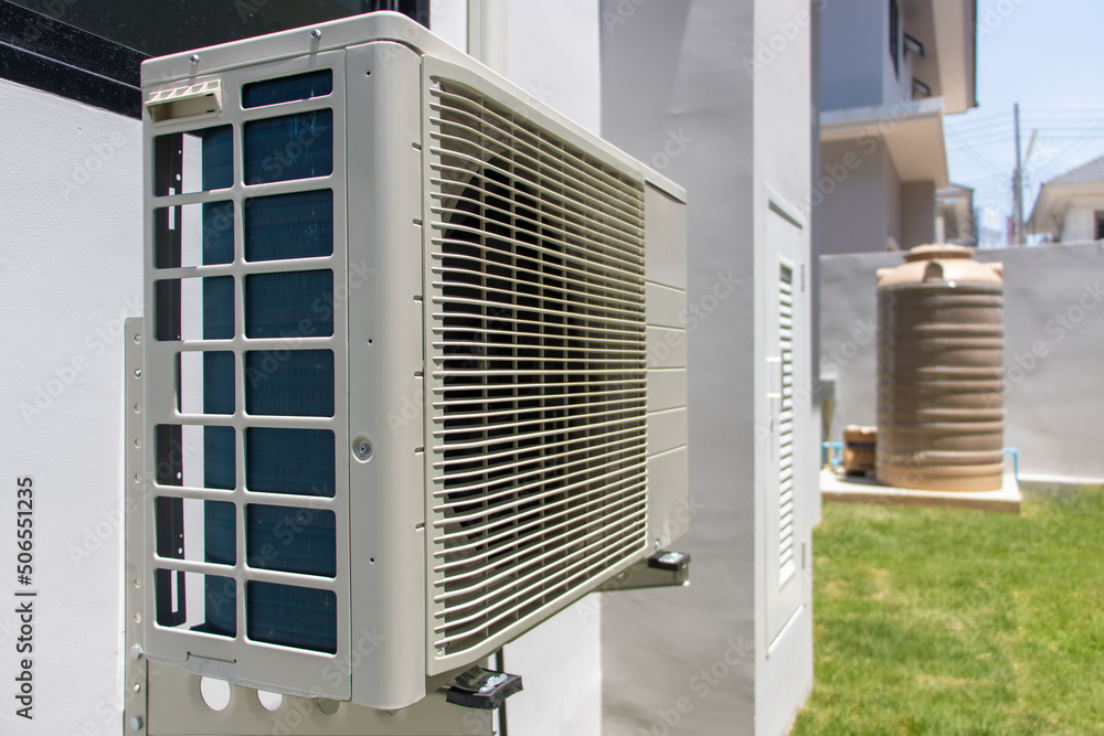 Air conditioner compressor outdoor unit installed on a facade of the house Air conditioner compressor outdoor unit installed on a facade of the house