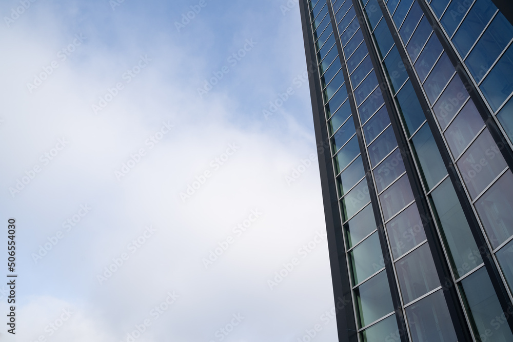 Big glass facade office building in the sky with copy space on the left Big glass facade office building in the sky with copy space on the left
