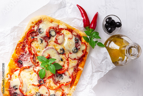 Pizza and vegetables on a light background photo