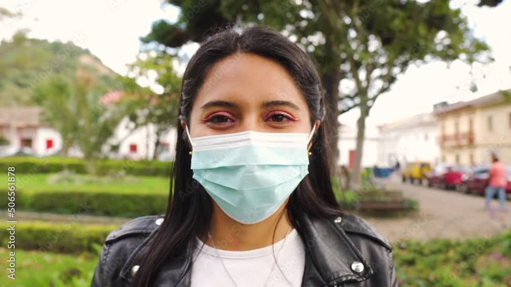 beautiful young latina brunette puts on a mask for pandemic return beautiful young latina brunette puts on a mask for pandemic return