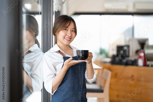 Portrait of woman barista startup successful small Asian business owner in coffee shop.Asian woman barista cafe owner. SME entrepreneur seller business concept