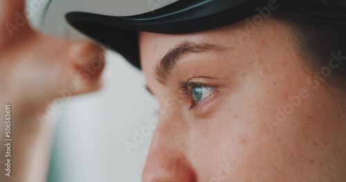 Close up of eyes of young woman putting vr goggles on and off