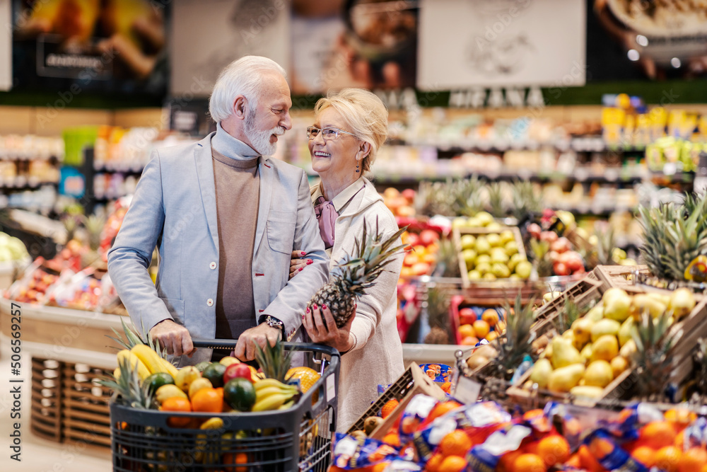 Senior couple buying fruits at supermarket.