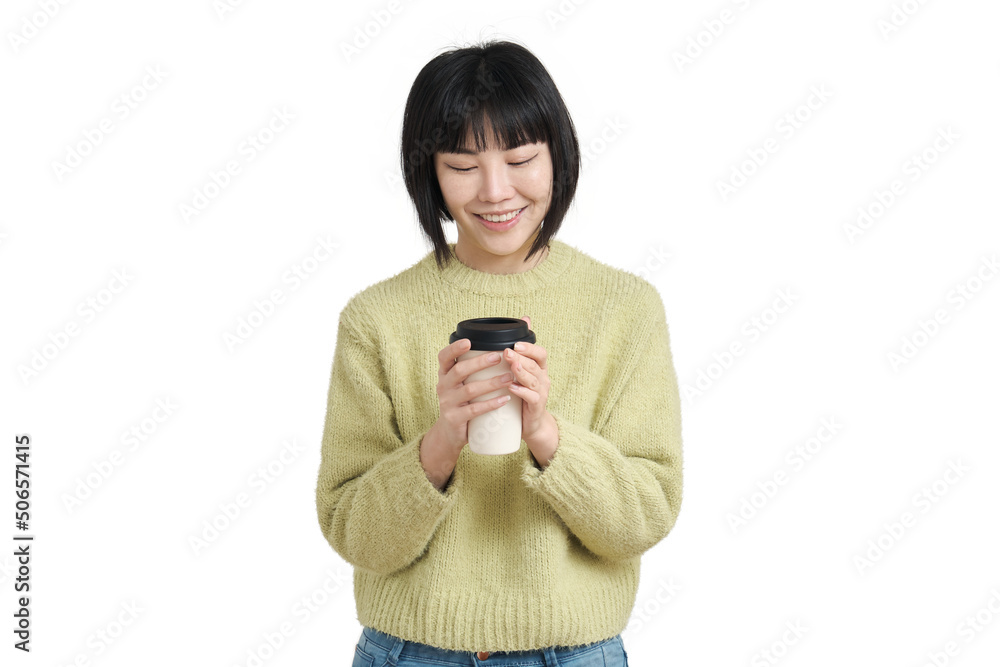 Young asian woman smiling with a coffee cup, wearing winter green sweater, isolated on white background. Young asian woman smiling with a coffee cup, wearing winter green sweater, isolated on white background.
