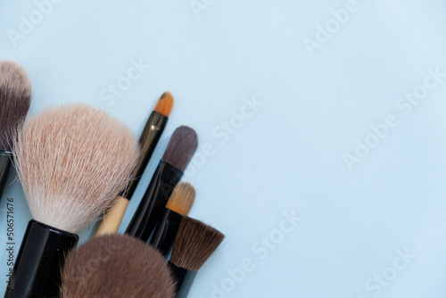 Set of makeup brushes on a blue background. Variable focus