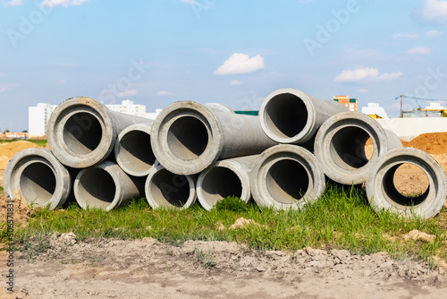 Water pipes for drinking water supply lie on the construction site. Preparation for earthworks for laying an underground pipeline. Modern water supply systems for a residential city.