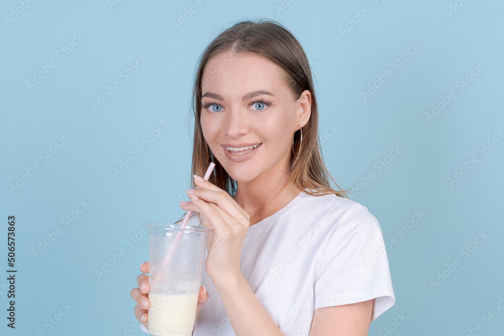 Follow me followers. Concept social influence. Close up studio photo portrait hipster carefree girl holding cocktail in her hand, wearing light clothes isolated blue pastel background Follow me followers. Concept social influence. Close up studio photo portrait hipster carefree girl holding cocktail in her hand, wearing light clothes isolated blue pastel background