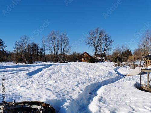 spring day in the Russian village snow well blue sky