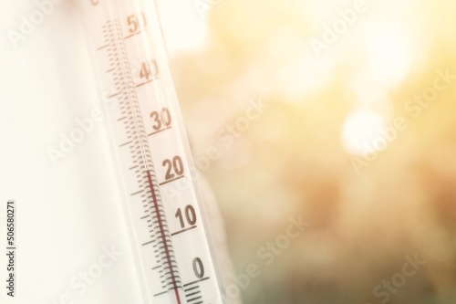 Outdoor thermometer outside the window of the house is close-up. Thermometer scale with plus air temperature. A device for determining the air temperature outside the house. Selective focus