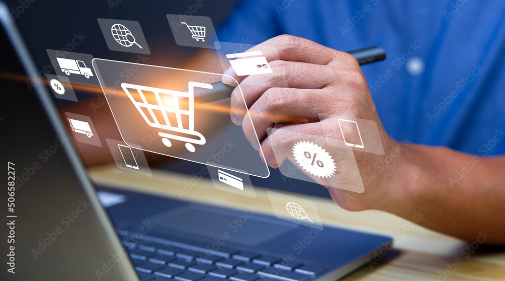 Fototapeta premium Shopper using computer laptop to input order with trolley credit card delivery truck for online shopping and e-commerce technology concept.