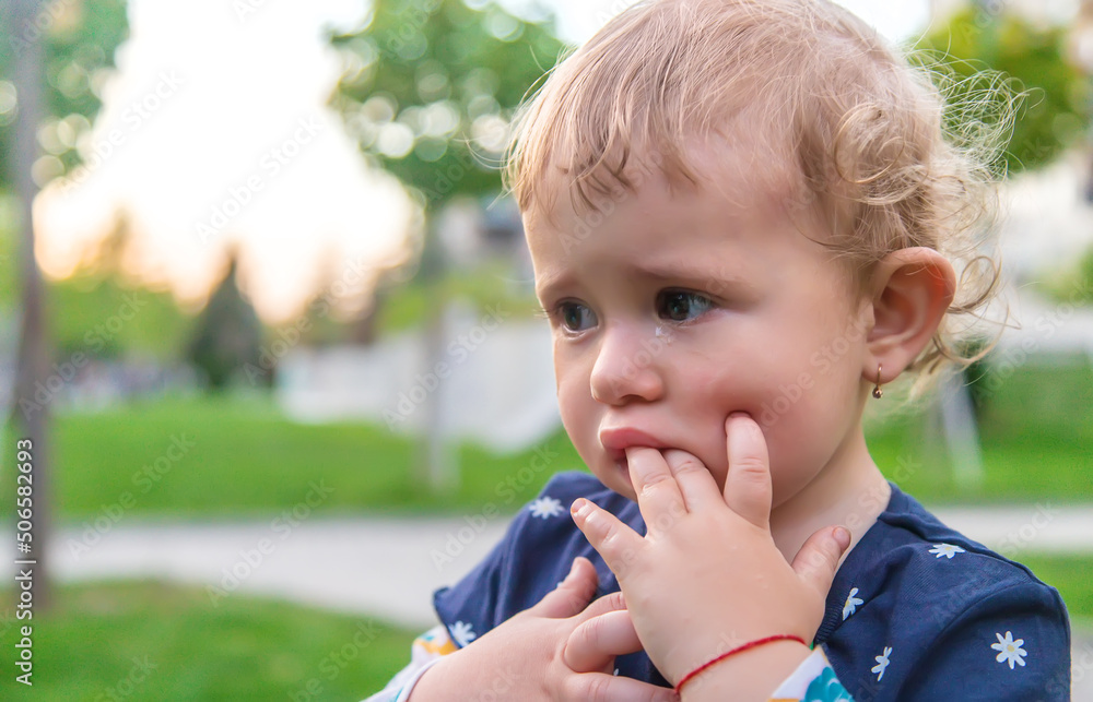 Baby crying in the park. Selective focus. Baby crying in the park. Selective focus.