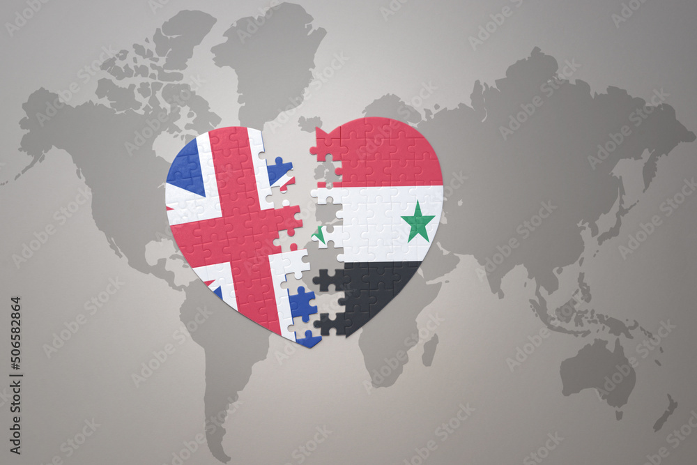 puzzle heart with the national flag of syria and great britain on a world map background. Concept. puzzle heart with the national flag of syria and great britain on a world map background. Concept.