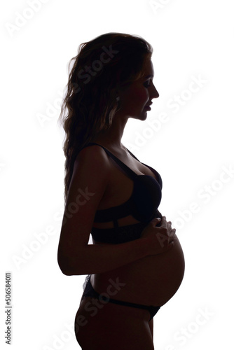 A young white pregnant woman is nine months pregnant on a bright background