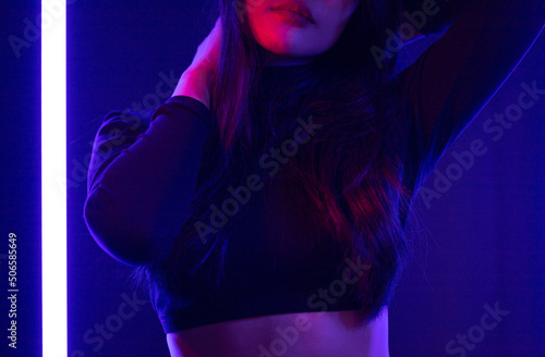 Stylish sexy woman in trendy. Beautiful young asian woman standing pose with neon light. Asia Pretty asian female in the dark room. Fashion shot. © Chanakon