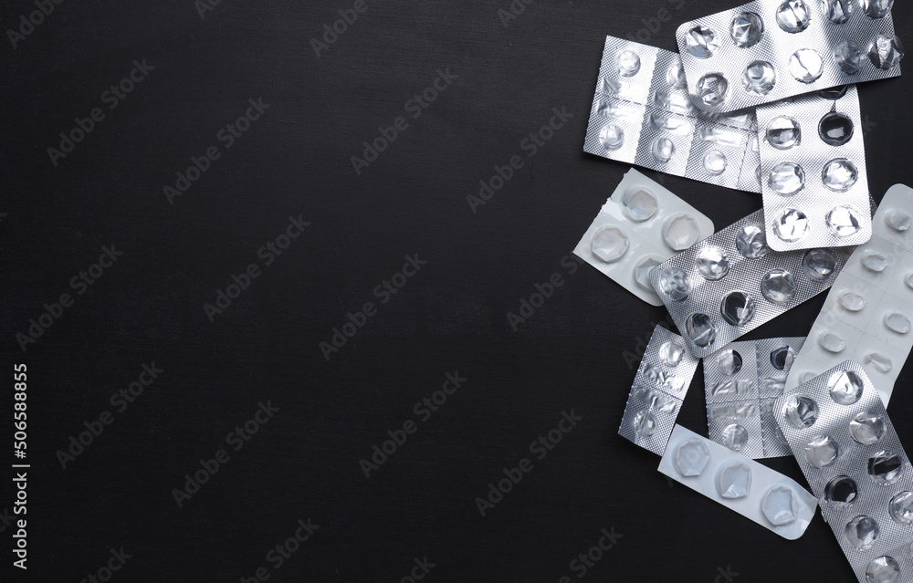 Empty tablet packs on a board with free space for your text Empty tablet packs on a board with free space for your text