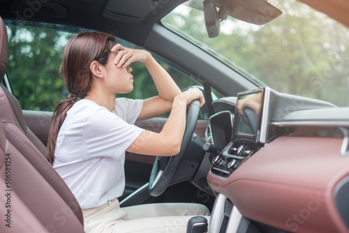woman feeling stress and angry during drive car long time. Asian girl tired and fatigue having headache stop after driving car in traffic jam. Sleepy, stretching and drunk concept photo