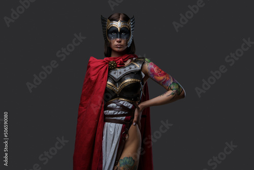 Portrait of woman warrior with tattooed body from past dressed in light armor.