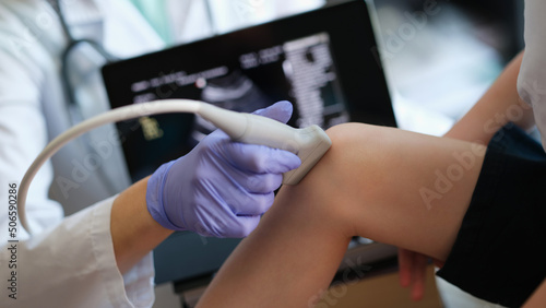 Fototapeta Naklejka Na Ścianę i Meble -  Ultrasound procedures of knee joint of small child in hospital