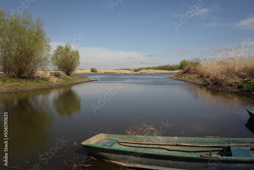 landscape in danube delta, tulcea, romania, in parches, with traditional wooden boats © Photowards