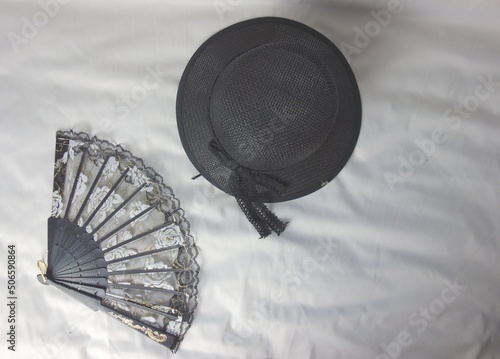 Canvas Print black fan and black summer hat for women