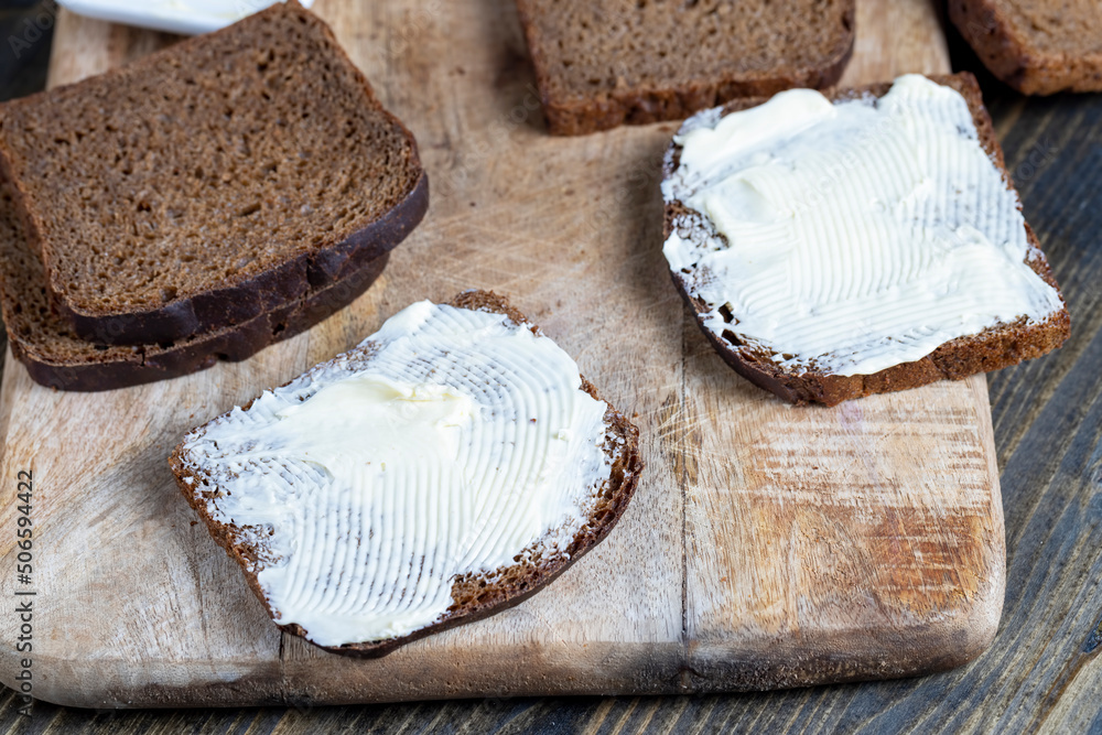slices of black sliced bread with butter spread from milk slices of black sliced bread with butter spread from milk