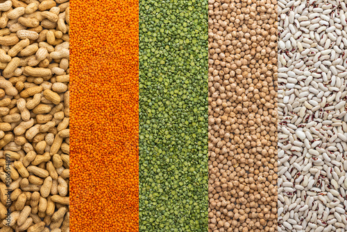 Different types of legumes, chickpeas and lentils and peanuts, white beans and green peas , top view