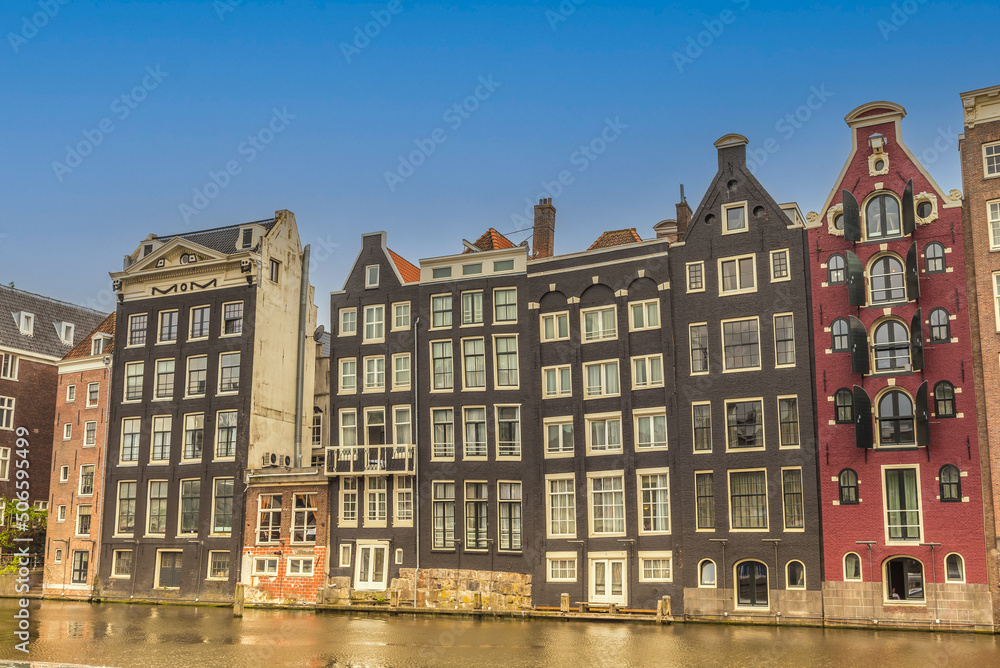 Amsterdam, Netherlands, May 2022. The dancing houses on the Damrak in Amsterdam.
