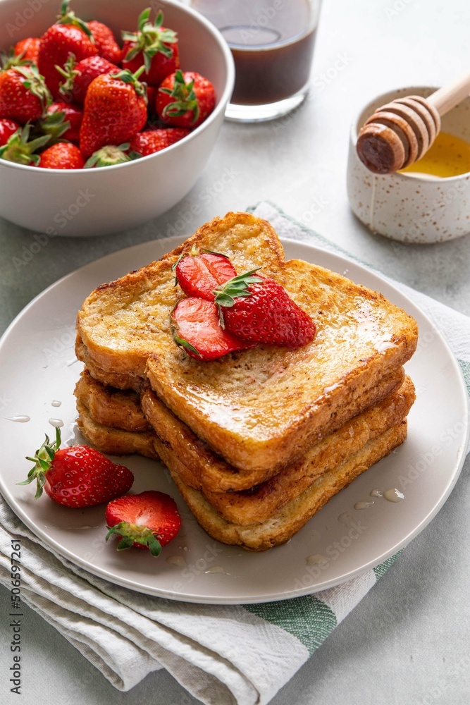 Homemade french cinnamon toast with strawberries, honey and coffee. Morning breakfast, brunch or lunch concept. Selective focus. Homemade french cinnamon toast with strawberries, honey and coffee. Morning breakfast, brunch or lunch concept. Selective focus.