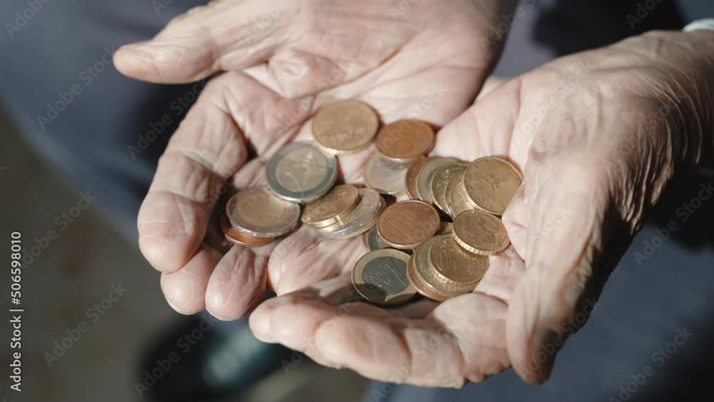 Miserable budget of senior man in retirement, old grandfather holding coins in his wrinkled hands, abandoned elderly man needs financial social assistance. Concept of poverty among pensioners during Miserable budget of senior man in retirement, old grandfather holding coins in his wrinkled hands, abandoned elderly man needs financial social assistance. Concept of poverty among pensioners during
