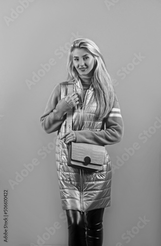 Pretty beautiful woman wearing jacket over isolated gray background looking confident with smile on face.