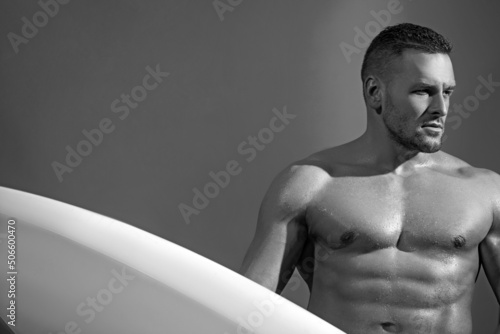 Male bodyboard surfing man good looking standing with surf board during vacation holidays getaway.