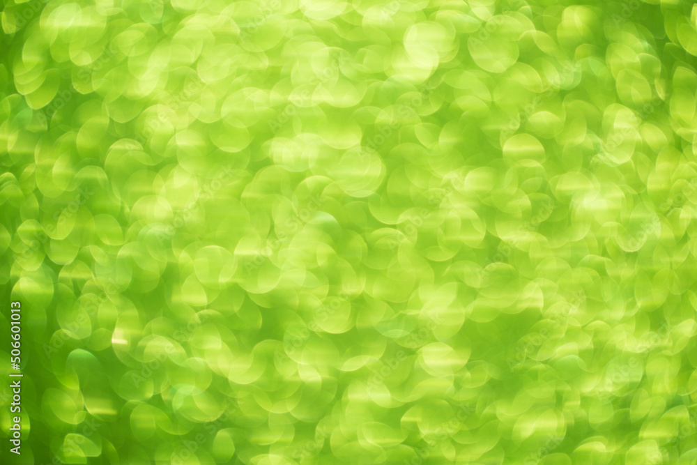 Green bokeh background. Festive Christmas shiny background. Glittering green light. Green bokeh background. Festive Christmas shiny background. Glittering green light.
